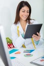 female nutritionist working on digital tablet in office Royalty Free Stock Photo