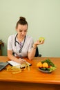 Female nutritionist working at her desk. Right nutrition and diet. Royalty Free Stock Photo