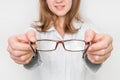 Female oculist doctor giving glasses to patient