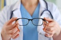 Female oculist doctor hands giving pair of glasses. Good vision Royalty Free Stock Photo