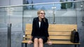 Female office employee sitting on bench, worrying bout troubles at work, stress Royalty Free Stock Photo