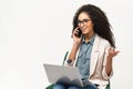 Female office employee typing and connecting with customers. Confident African-American woman in smart casual wear using Royalty Free Stock Photo