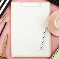 Female office supplies with empty clipboard on pastel pink background