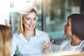 Female office worker on a break with colleagues talking and having a conversation at work. Business people spending time Royalty Free Stock Photo