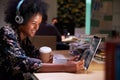 Female Office Worker With Coffee At Desk Working Late Royalty Free Stock Photo