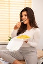 Female office worker eating Asian food from takeaway box Royalty Free Stock Photo