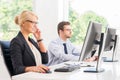 Female office worker in formalwear with her colleague Royalty Free Stock Photo