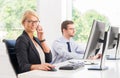 Female office worker in formalwear with her colleague Royalty Free Stock Photo