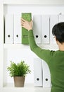 Female office worker with green folder