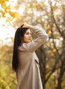 female office worker has fun in autumn park during lunch time,solitude with nature. Stress relief.Vertical plane Royalty Free Stock Photo