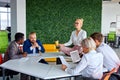 Female office worker is meditating, taking break at work for mental balance Royalty Free Stock Photo