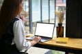 A female office worker, remote working and using her portable laptop in a coffee shop Royalty Free Stock Photo