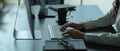 Female office worker typing on computer keyboard on office desk Royalty Free Stock Photo