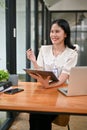 A female office worker is working at her desk in the office, getting a new idea for her project Royalty Free Stock Photo