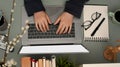 Female officer typing on laptop keyboard in her modern workspace Royalty Free Stock Photo