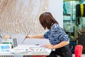 A female oil painting artist painting on canvas  in the Dafen Oil painting village, Shenzhen, Guangdong province, China Royalty Free Stock Photo