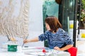 A female oil painting artist painting on canvas  in the Dafen Oil painting village, Shenzhen, Guangdong province, China Royalty Free Stock Photo