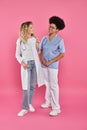 female oncologists, interracial doctors in white Royalty Free Stock Photo