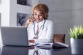 Female online doctor speaking on the phone Royalty Free Stock Photo