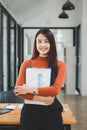 Female operations manager holds meeting presentation for a team of economists.