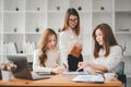 Female operations manager holds meeting presentation for a team of economists.