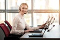 Female operator with headset smiling.