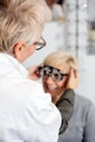 Female ophthalmologist examining mature woman at the ophthalmology clinic, determining diopter Royalty Free Stock Photo