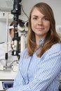 Female Optician Giving Male Client Eye Examination