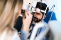 Optometrist checking patient eyesight and vision correction Royalty Free Stock Photo