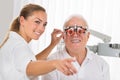 Female Optometrist Checking Patient`s Vision With Trial Frame Royalty Free Stock Photo