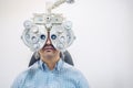 Optometrist eyesight exam, man patient in optician office Royalty Free Stock Photo