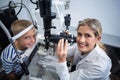 Female optometrist examining young patient on slit lamp Royalty Free Stock Photo
