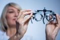 Female optometrist looking at messbrille Royalty Free Stock Photo