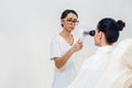 Female optometrist with special equipment checking patient vision at eye clinic Royalty Free Stock Photo