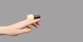 Female with orange nail design. Glitter orange nail polish manicure with red nail art. Woman hand hold yellow nail polish bottle Royalty Free Stock Photo