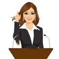 Female orator standing behind a podium with microphones Royalty Free Stock Photo