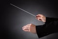 Female orchestra conductor with baton Royalty Free Stock Photo