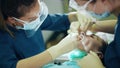 Female orthodontist wearing face mask and protective face shield at work Royalty Free Stock Photo