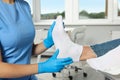 Female orthopedist examining patient`s foot in hospital, closeup Royalty Free Stock Photo