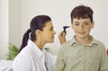 Otorhinolaryngologist uses otoscope to examine child& x27;s ear during medical examination in hospital. Royalty Free Stock Photo