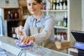 Female Owner Delicatessen Cleaning Counter With Sanitising Spray