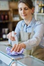 Female Owner Delicatessen Cleaning Counter With Sanitising Spray