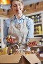 Female Owner Of Delicatessen Food Shop With Digital Tablet Preparing Online Grocery Order