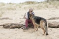 Female owner giving pet Alsatian a drink of water on a hot sunny day Royalty Free Stock Photo