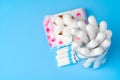 Female pads and tampons on blue paper background