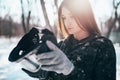 Female paintball player puts on protection mask