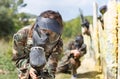 Female paintball player shooting with gun Royalty Free Stock Photo