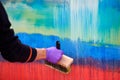 Female painter hand drawing abstract oil painting holding wide brush, painting on colorful canvas Royalty Free Stock Photo