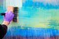 Female painter hand drawing abstract oil painting holding wide brush, painting on colorful canvas Royalty Free Stock Photo