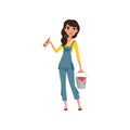 Female painter in uniform standing with paint brush and bucket in her hands, house renovation concept vector